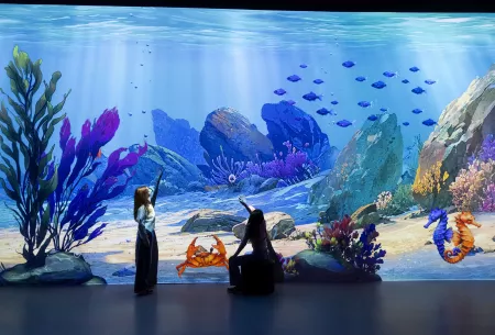 Kind an der interaktiven Wand