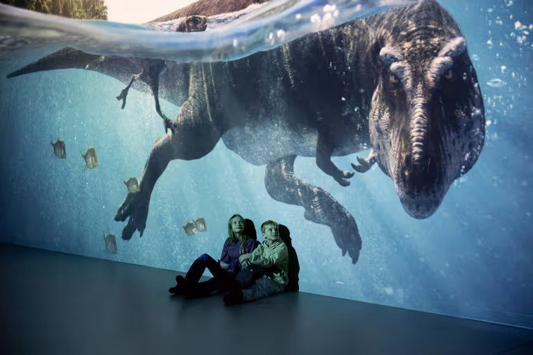 children and dinosaurs underwater
